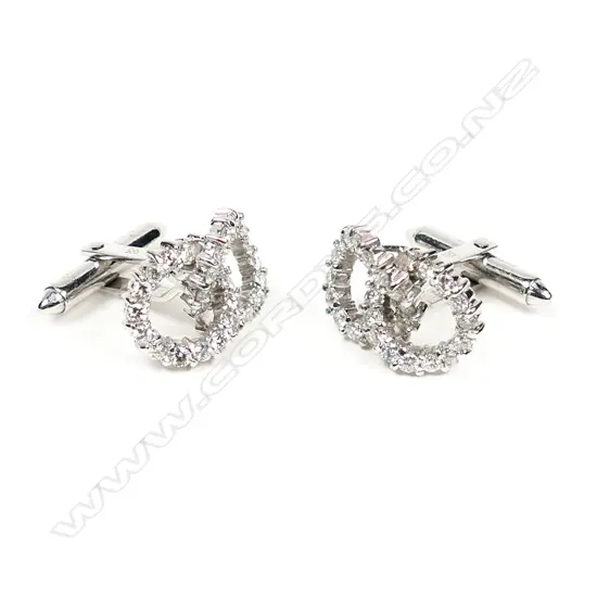 A pair of diamond set 14ct white gold double circlet cufflinks, each of two interlocked circles set with 28 round brilliant cut diamonds on hinged bar backs. The 56 diamonds of approx. TDW 2.20ct. Valuation available.