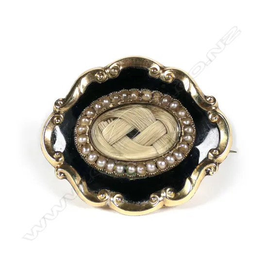 A 19thC 9ct gold memorial brooch, black enamel and seed pearl band framing the plaited hair panel.