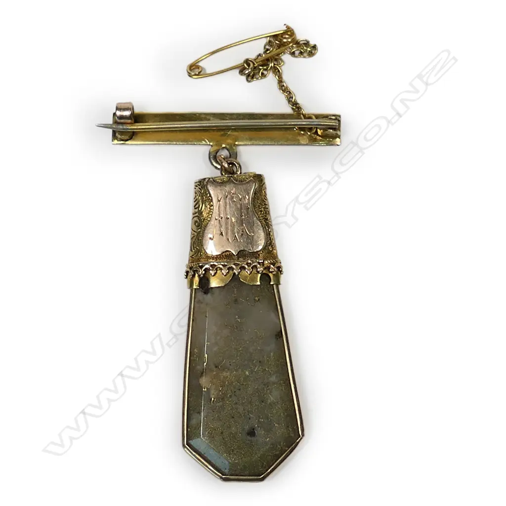 A colonial 15ct gold and gold bearing quartz pendant, the elongated hexagonal form pendant with plain gold frame and decorative cap with suspension ring, attached to a later 9ct rose gold bar brooch. Image 1++