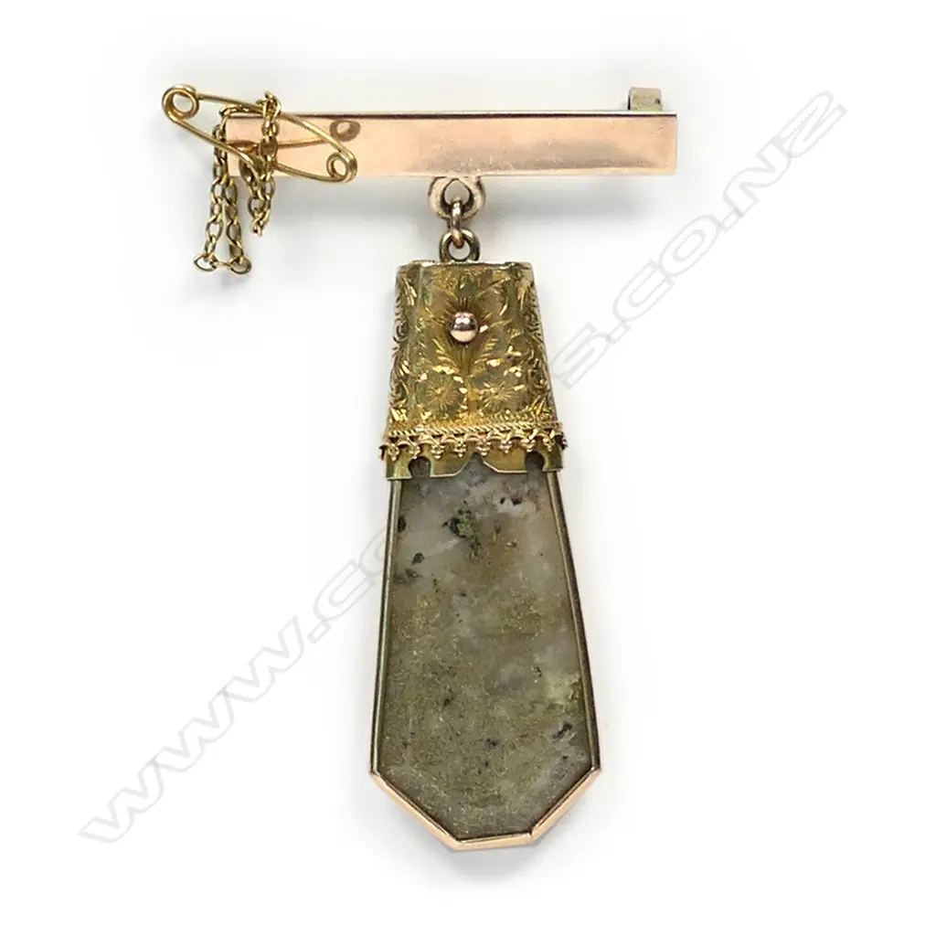 A colonial 15ct gold and gold bearing quartz pendant, the elongated hexagonal form pendant with plain gold frame and decorative cap with suspension ring, attached to a later 9ct rose gold bar brooch. Image 1++