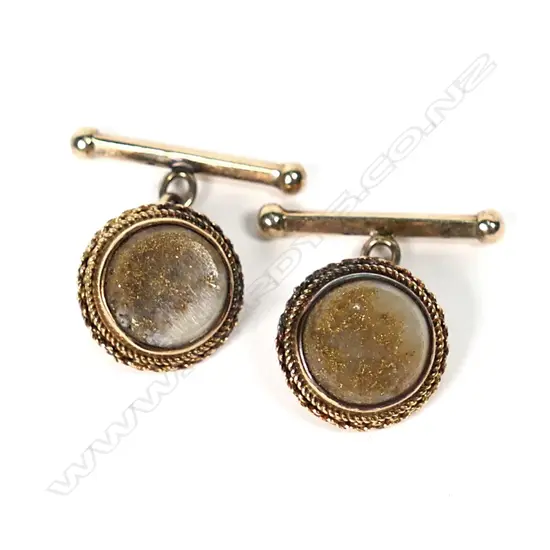 A pair of 15ct gold and gold bearing quartz cufflinks, the round polished quartz bezel set with rope and chain link detail, chain links to small straight dumbbell, 6.1gm.