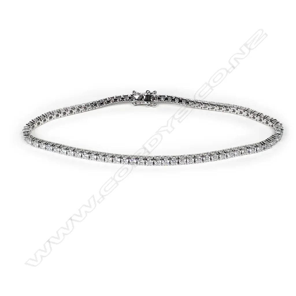 An 18ct white gold and diamond tennis bracelet, round brilliant cut diamonds claw set, push clasp with two safety catches, TDW 2.82ct. Image 1++