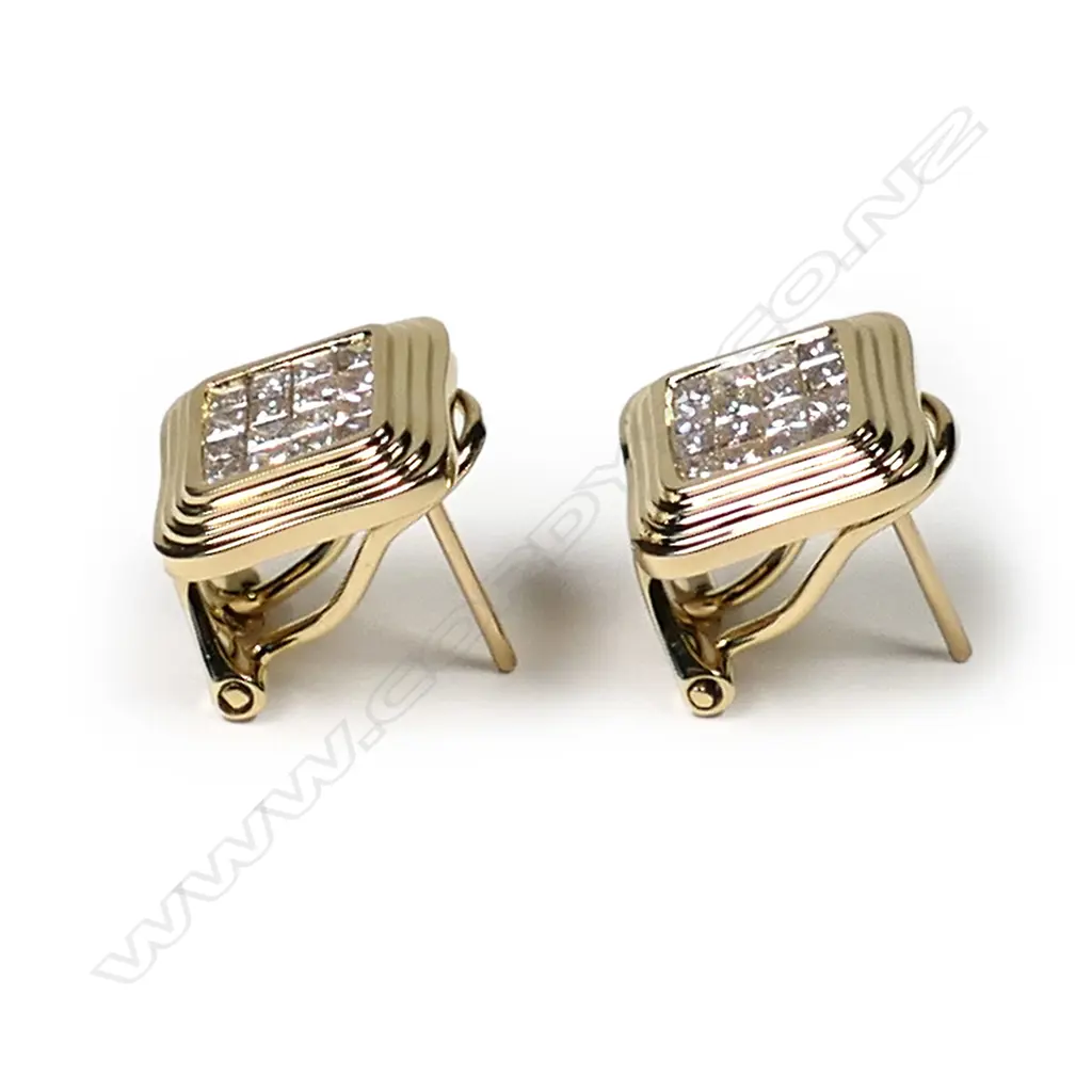 A pair of 18ct yellow gold and diamond stud earrings, each earring set with sixteen princess cut diamonds in a square mount with fluted decoration, posts for pierced ears with safety clips, TDW 0.74ct. Image 1++