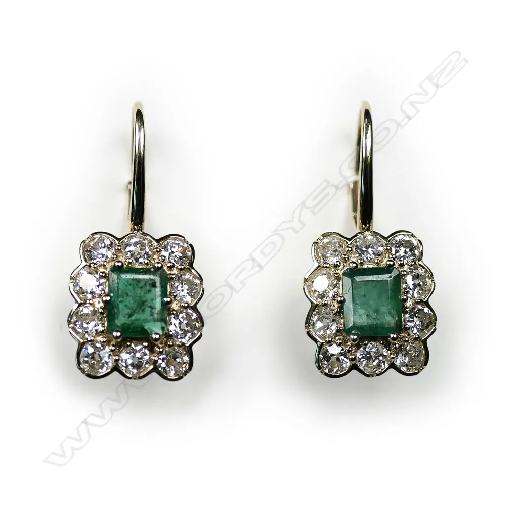 A pair of 14ct gold emerald and diamond vintage style drop earrings, each earring set with a 0.57ct emerald cut, bluish-green emerald (eye visible inclusions), claw set and surrounded by a halo of ten round old European cut diamonds (H-I colour, SI2-I2 clarity), lever backs for pierced ears, TEW 1.15ct, TDW 1.58ct. Image 1++