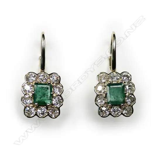 A pair of 14ct gold emerald and diamond vintage style drop earrings, each earring set with a 0.57ct emerald cut, bluish-green emerald (eye visible inclusions), claw set and surrounded by a halo of ten round old European cut diamonds (H-I colour, SI2-I2 clarity), lever backs for pierced ears, TEW 1.15ct, TDW 1.58ct.