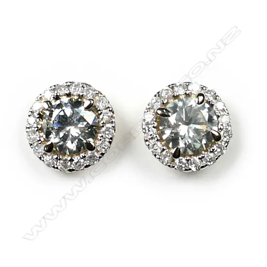 A pair of 14ct gold diamond halo stud earrings, each earring set with a 0.58ct round brilliant cut diamonds (M-N colour, SI2-I1 clarity), claw set and surrounded by sixteen round brilliant cut diamonds (J-K colour, SI1-I2 clarity), posts for pierced ears, TDW 1.33ct.
