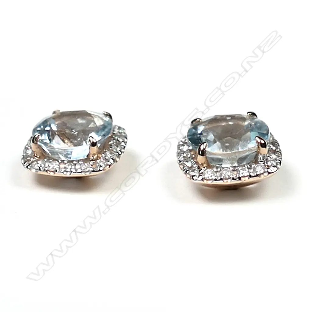 A pair of 14ct rose gold aquamarine and diamond halo stud earrings, each earring set with a 1.65ct round cut, greyish-blue aquamarine (eye clean clarity), and surrounded by a halo of eighteen round brilliant cut diamonds (H-J colour, SI2-I2 clarity), posts for pierced ears, TDW 0.28ct, TAW 3.31ct. Image 1++