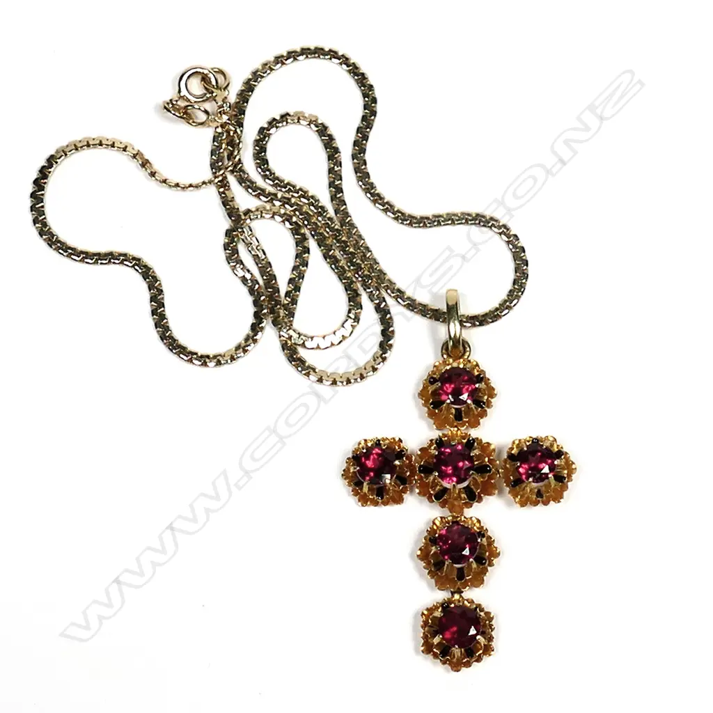 A Victorian 18ct gold and enamel cross pendant, the cross set with six facet cut almandine garnets claw set in a double floral mount with restrained black enamel detail, together with a 14ct gold box chain, 5.2gm (cross), 4.2gm chain. Image 1++