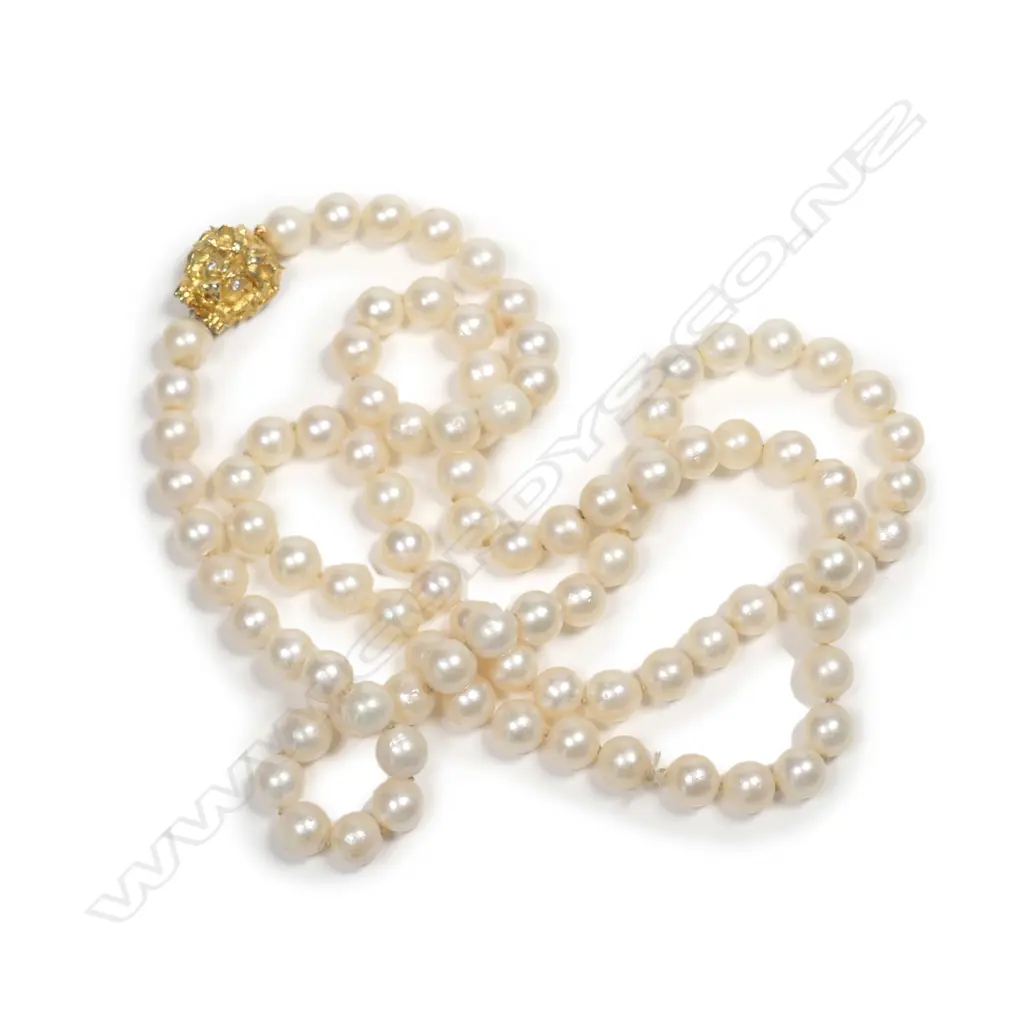 A cultured pearl necklace with 14ct gold clasp, a single strand of ninety-five 7.8mm uniform round deep cream pearls, the 14ct gold clasp in the form of a lion’s head with diamond eyes. Image 1++