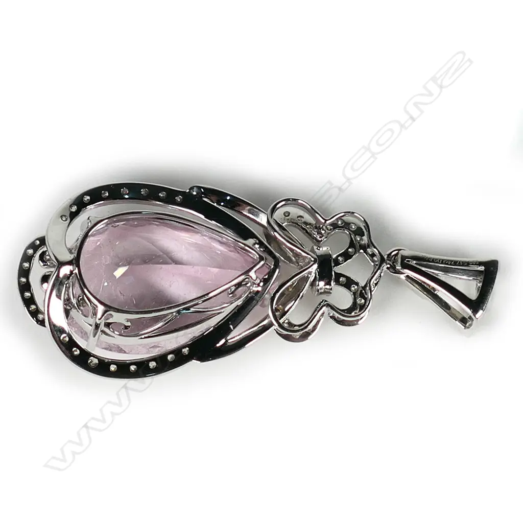 An impressive 14ct white gold morganite and diamond pendant, a 17.74ct pear cut medium pink morganite (visible inclusions), claw set and surrounded by a semi halo of round brilliant cut diamonds with a diamond encrusted bow to the top, suspended from a diamond set bale (J-L/champagne colour, SI1-I1 clarity), TDW 0.81ct. Image 1++