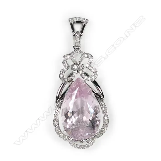 An impressive 14ct white gold morganite and diamond pendant, a 17.74ct pear cut medium pink morganite (visible inclusions), claw set and surrounded by a semi halo of round brilliant cut diamonds with a diamond encrusted bow to the top, suspended from a diamond set bale (J-L/champagne colour, SI1-I1 clarity), TDW 0.81ct.