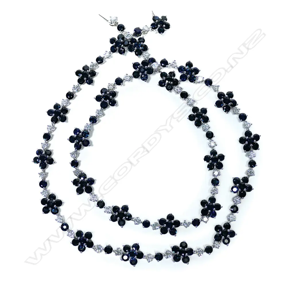 A 14ct white gold blue sapphire and diamond floral necklace Image 1++