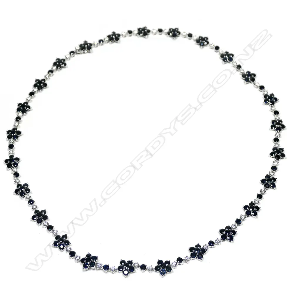 A 14ct white gold blue sapphire and diamond floral necklace Image 1++