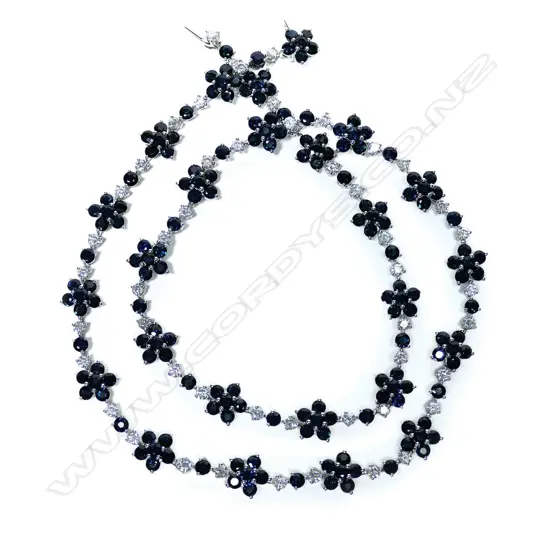 A 14ct white gold blue sapphire and diamond floral necklace