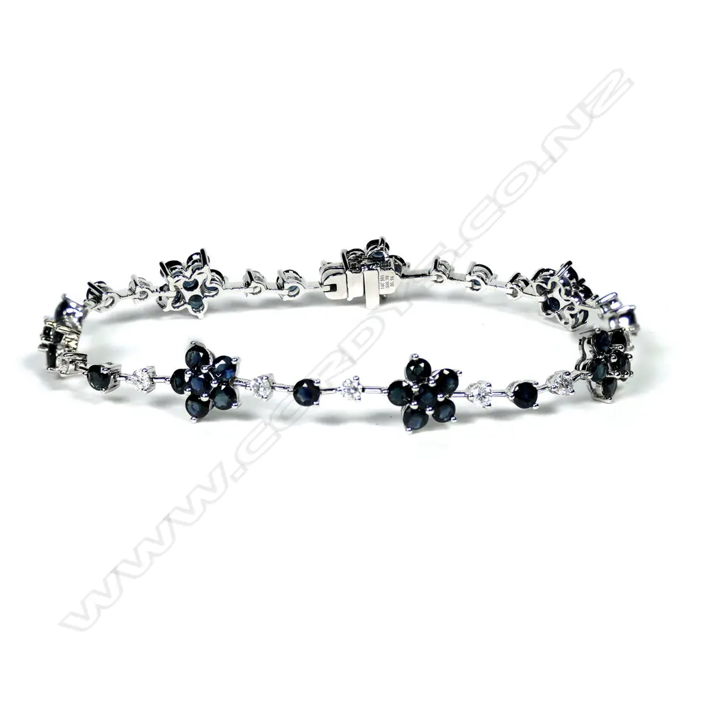 A 14ct white gold sapphire and diamond floral bracelet, matching the above necklace, TSW 6.99ct eye clean clarity, TDW 0.94ct, G-H colour, SI2-I2 clarity, push clasp with safety catch, L.180mm. Image 1++