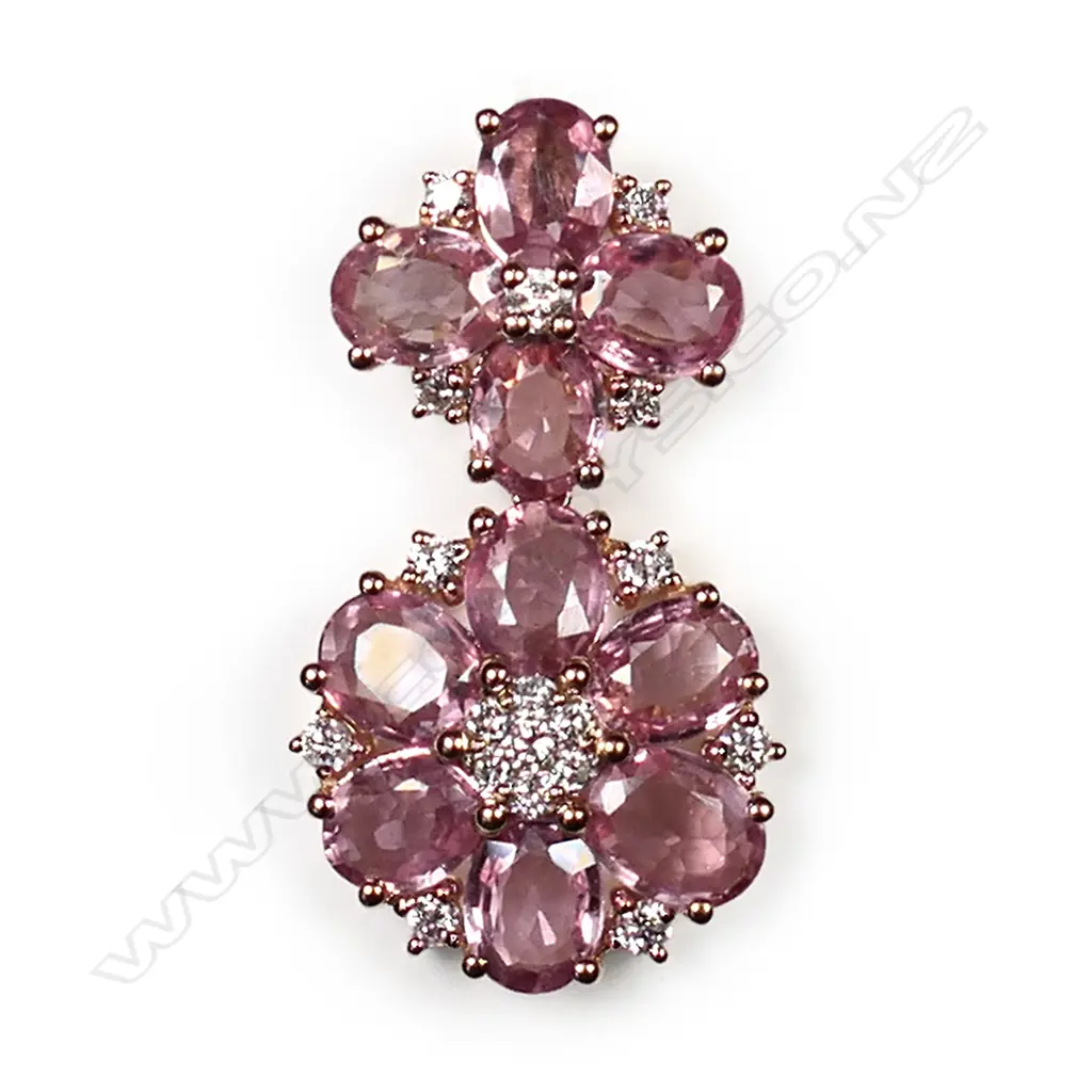 A 14ct rose gold, pink sapphire and diamond floral drop pendant, two floral drops set with oval cut medium-light orangish-pink sapphires (eye clean clarity), and eighteen round brilliant cut, diamonds (H-I colour, SI1-I2 clarity), TSW 3.60ct, TDW 0.25ct. Image 1++