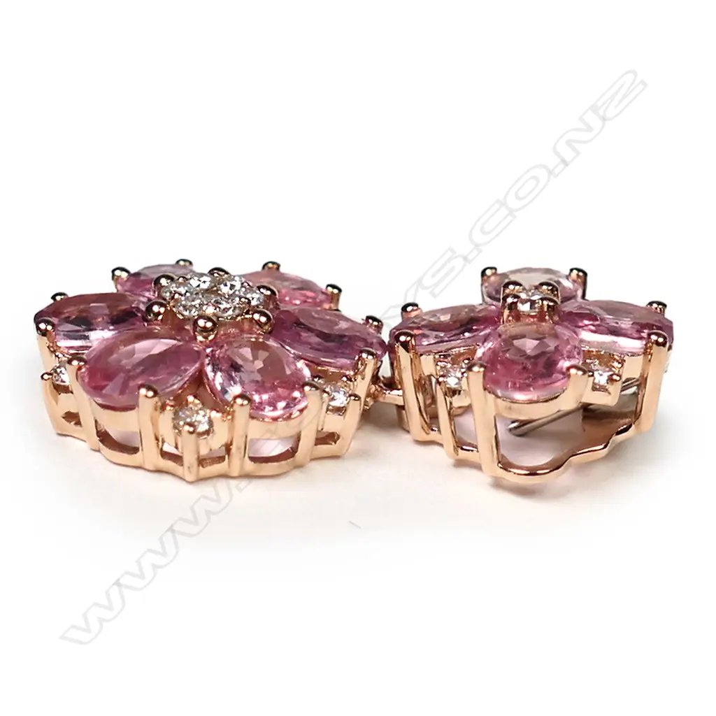 A 14ct rose gold, pink sapphire and diamond floral drop pendant, two floral drops set with oval cut medium-light orangish-pink sapphires (eye clean clarity), and eighteen round brilliant cut, diamonds (H-I colour, SI1-I2 clarity), TSW 3.60ct, TDW 0.25ct. Image 1++