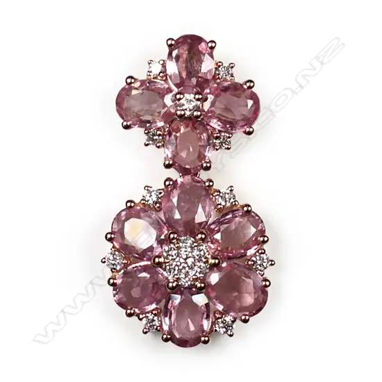 A 14ct rose gold, pink sapphire and diamond floral drop pendant, two floral drops set with oval cut medium-light orangish-pink sapphires (eye clean clarity), and eighteen round brilliant cut, diamonds (H-I colour, SI1-I2 clarity), TSW 3.60ct, TDW 0.25ct.