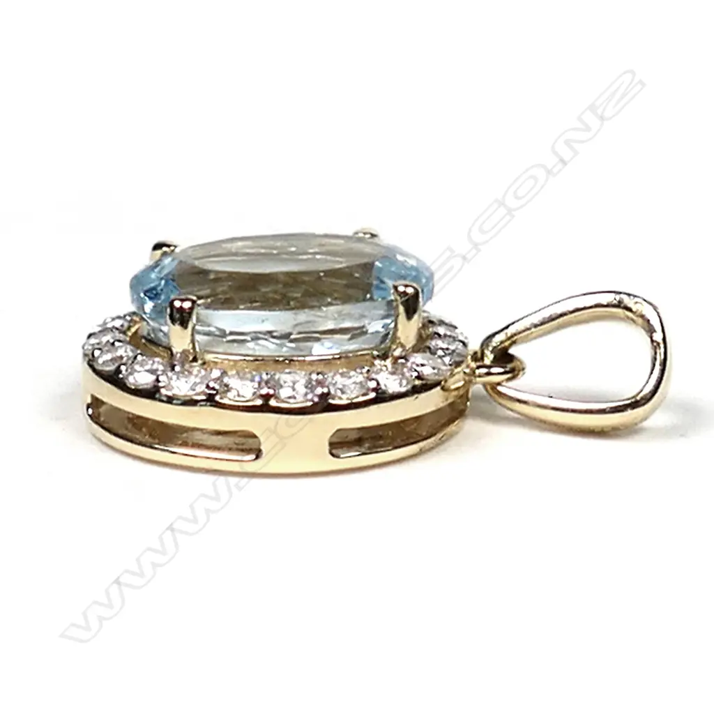 A 14ct gold, aquamarine and diamond halo pendant, a 2.85ct oval cut greyish-blue aquamarine (eye clean clarity), claw set and surrounded by a halo of twenty round brilliant cut diamonds, with a further four diamonds in the suspension bale, (G-H colour, SI1-I2 clarity), TDW 0.34ct. Image 1++