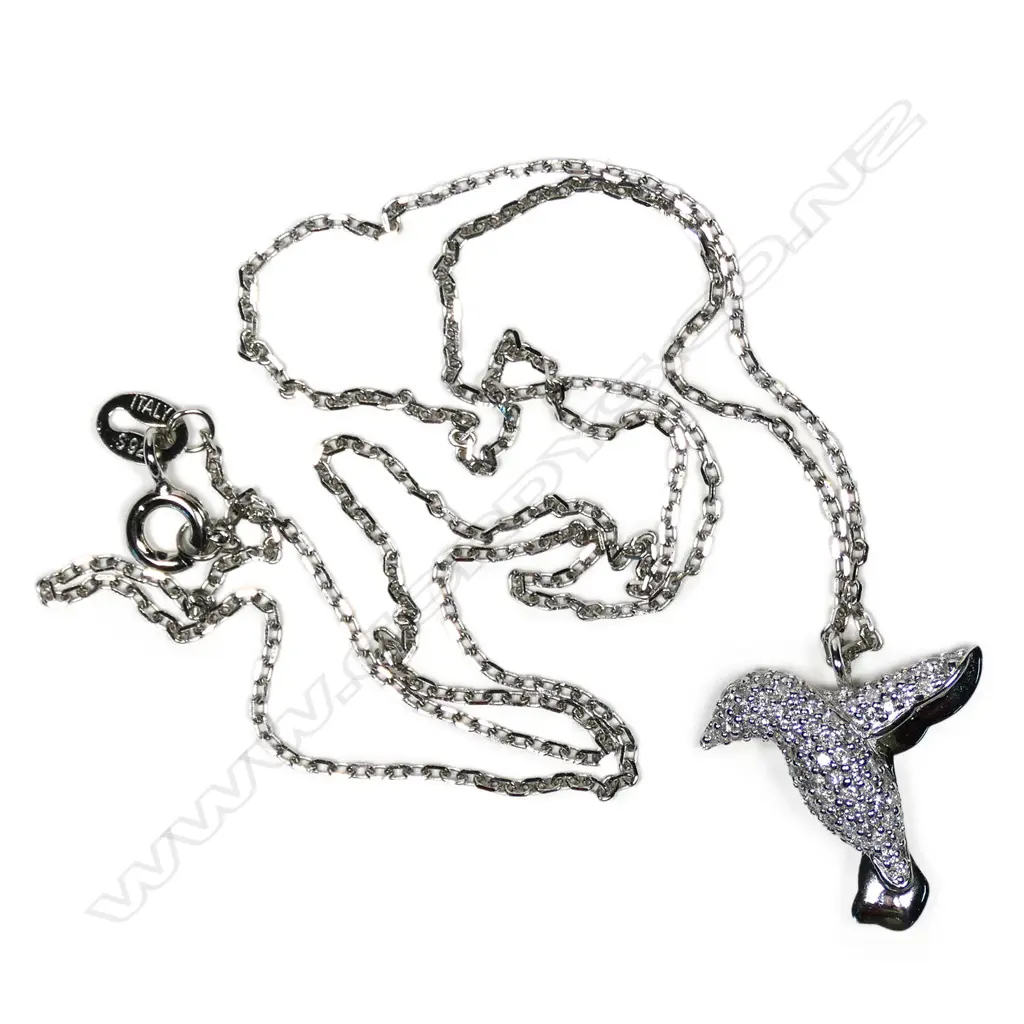 A 9ct white gold and diamond pendant, in the shape of a bird in flight, pave set with small diamonds, TDW 0.35ct, together with a sterling silver chain. Image 1++