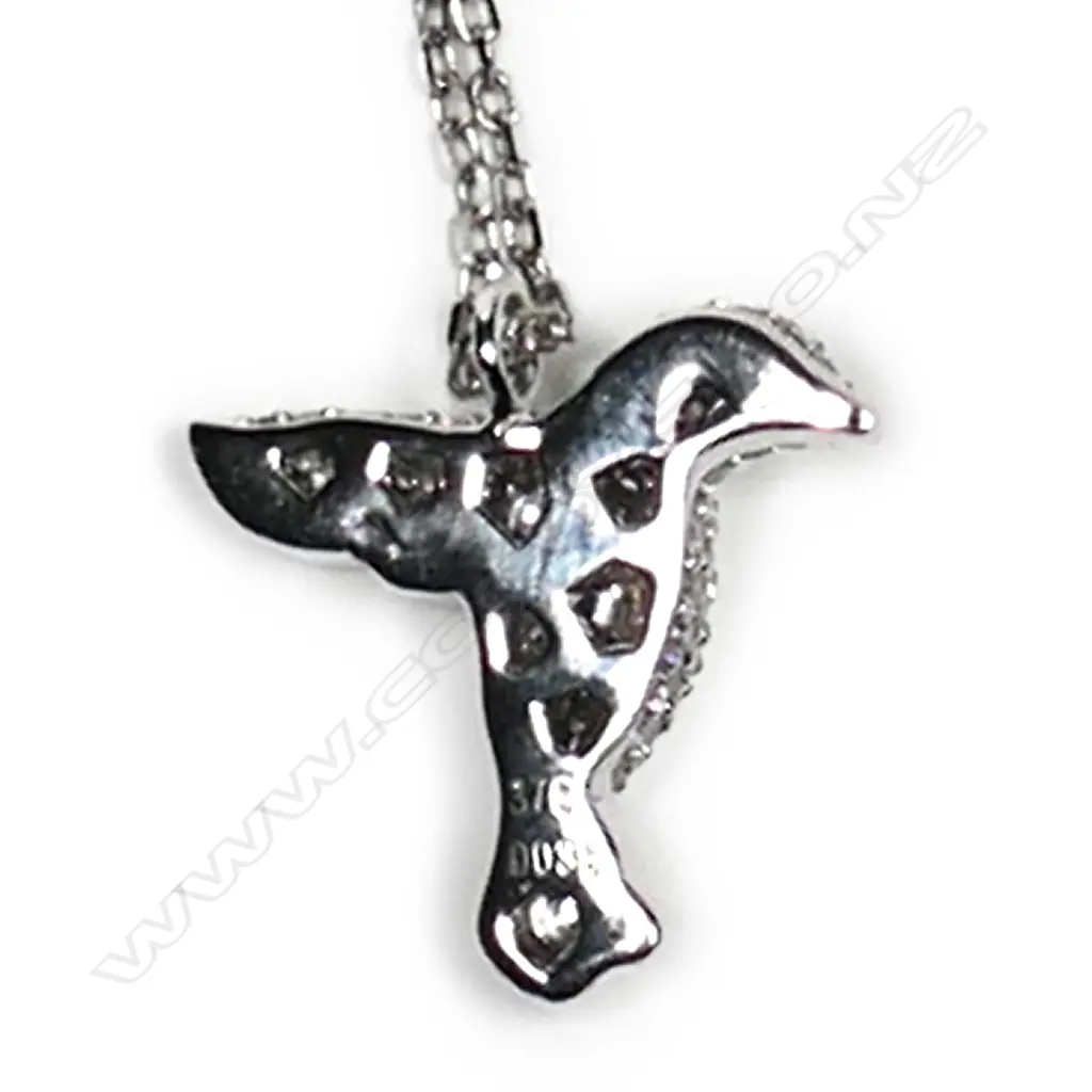 A 9ct white gold and diamond pendant, in the shape of a bird in flight, pave set with small diamonds, TDW 0.35ct, together with a sterling silver chain. Image 1++