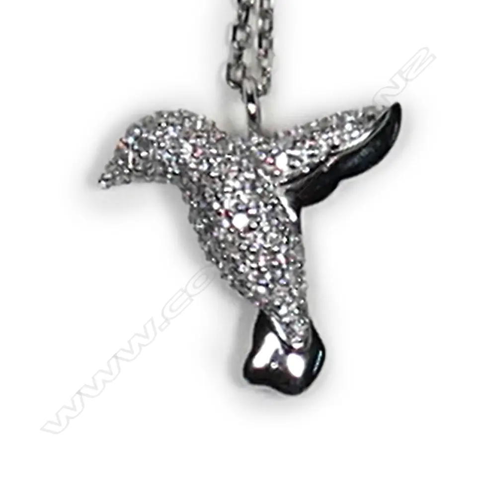 A 9ct white gold and diamond pendant, in the shape of a bird in flight, pave set with small diamonds, TDW 0.35ct, together with a sterling silver chain. Image 1++