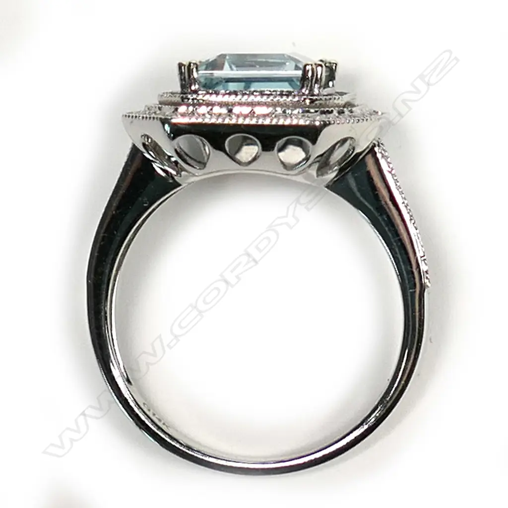 A 14k white gold aquamarine diamond and sapphire ring, the octagonal cut 3.13ct aquamarine framed by rows of small sapphires and diamonds, further diamonds to the forked shoulders. With AIG certificate and valuation available. Image 1++