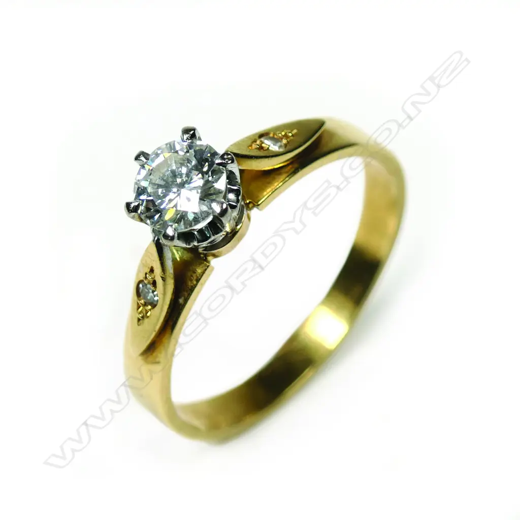 An 18ct gold diamond solitaire ring, the round brilliant cut of 0.44ct graded H-I and SI1, framed by two single cut diamonds. Valuation available. Image 1++