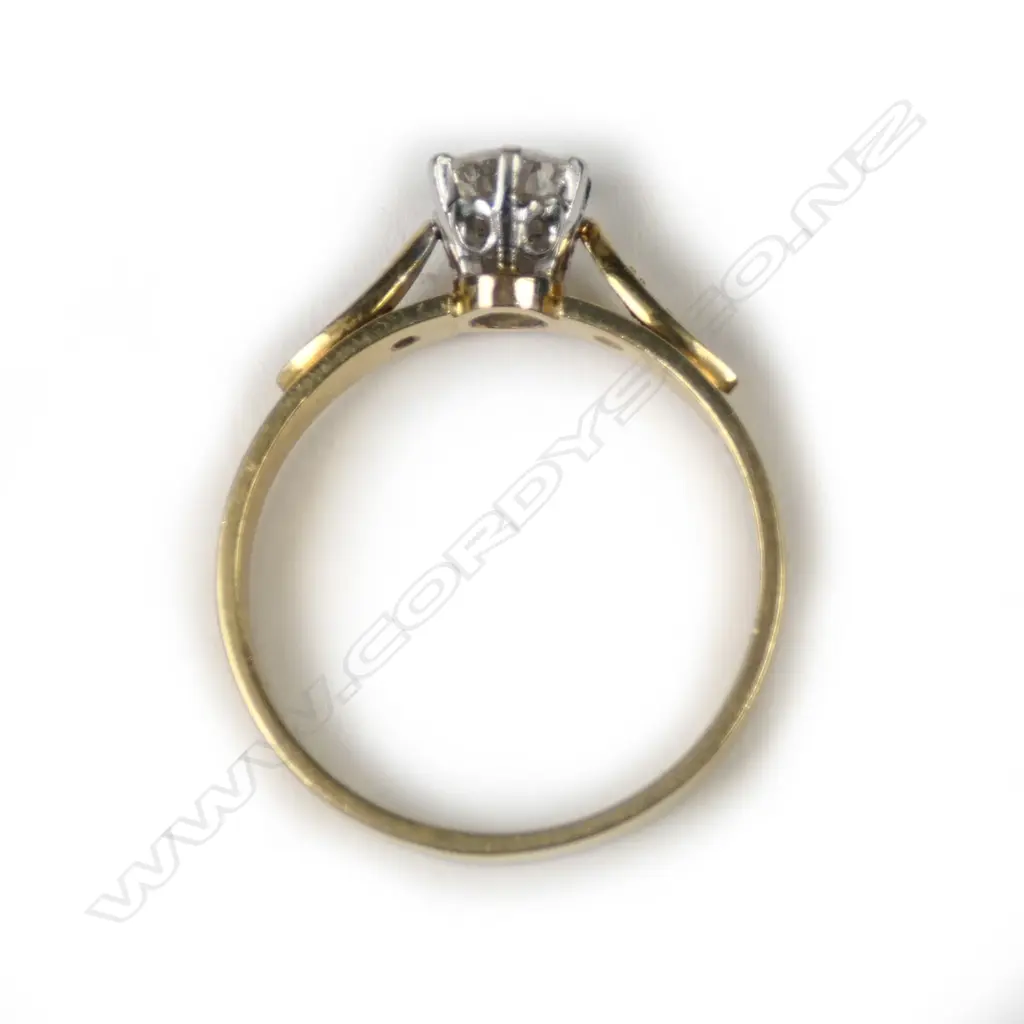An 18ct gold diamond solitaire ring, the round brilliant cut of 0.44ct graded H-I and SI1, framed by two single cut diamonds. Valuation available. Image 1++