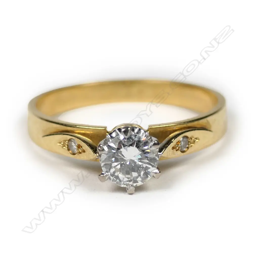 An 18ct gold diamond solitaire ring, the round brilliant cut of 0.44ct graded H-I and SI1, framed by two single cut diamonds. Valuation available. Image 1++