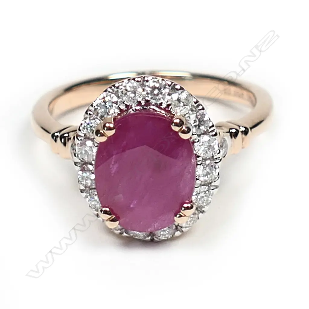 A 14ct rose gold ruby and diamond halo ring, a 2.35ct oval cut red ruby claw set and surrounded by round brilliant cut diamonds (I-J colour, SI1-I2 clarity), with a further brilliant cut diamond to each shoulder, (I-J colour, SI1-SI2 clarity), TDW 0.42ct ring size O. Image 1++