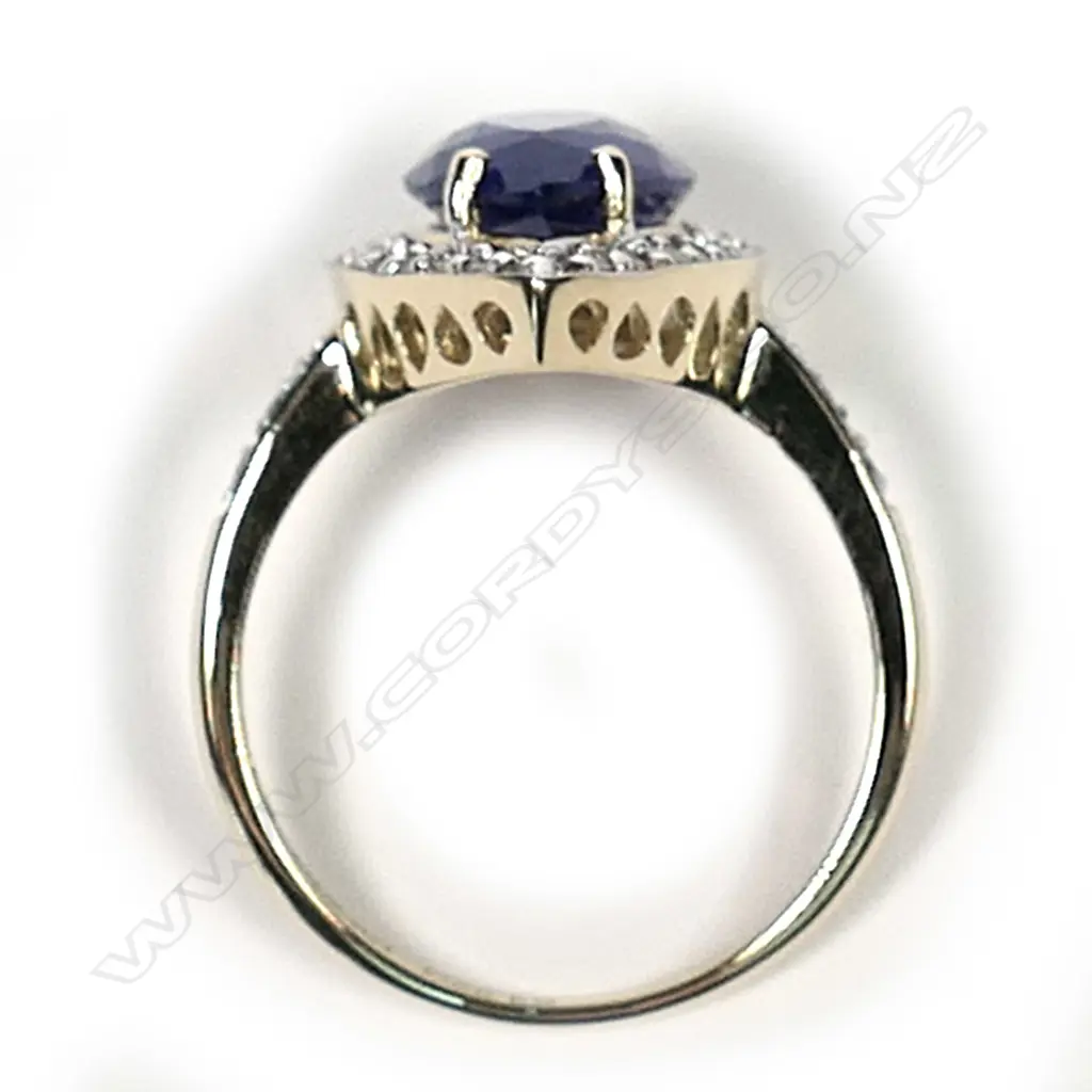 A 14ct gold tanzanite and diamond antique style halo ring, a 3.22ct pear faceted cut vivid violet blue tanzanite (moderate-heavy inclusions), claw set and surrounded by round brilliant cut diamonds with further diamonds to the band, (G-I colour, SI-I2 clarity) TDW 0.23ct, ring size N. Image 1++