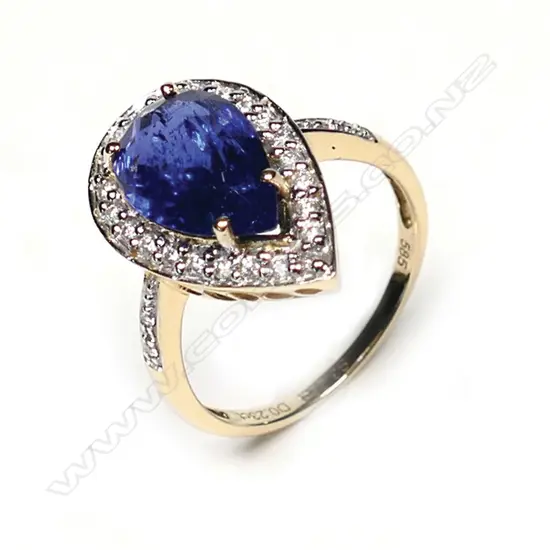 A 14ct gold tanzanite and diamond antique style halo ring, a 3.22ct pear faceted cut vivid violet blue tanzanite (moderate-heavy inclusions), claw set and surrounded by round brilliant cut diamonds with further diamonds to the band, (G-I colour, SI-I2 clarity) TDW 0.23ct, ring size N.