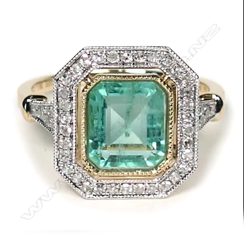 a 14ct gold Columbian emerald and diamond, antique style ring, a 1.93ct emerald cut, bluish-green Columbian emerald (minor eye visible inclusions), bezel set and surrounded by a halo of round brilliant cut diamonds with further diamonds to the shoulders, (G-H colour, SI1-I1 clarity), TDW 0.24ct ring size M. Image 1++