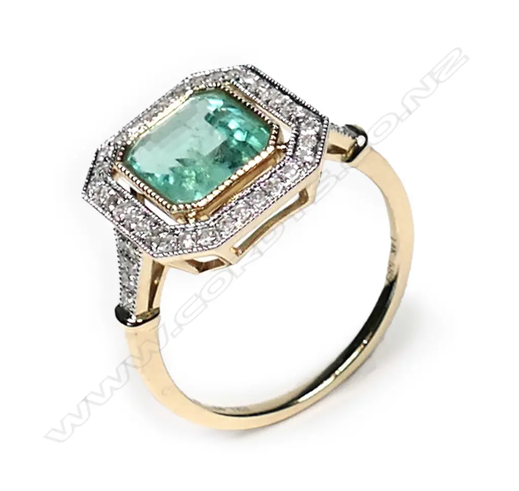 a 14ct gold Columbian emerald and diamond, antique style ring, a 1.93ct emerald cut, bluish-green Columbian emerald (minor eye visible inclusions), bezel set and surrounded by a halo of round brilliant cut diamonds with further diamonds to the shoulders, (G-H colour, SI1-I1 clarity), TDW 0.24ct ring size M. Image 1++