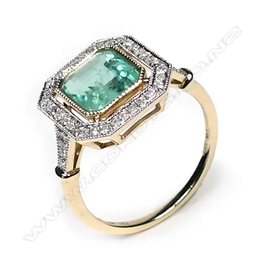 a 14ct gold Columbian emerald and diamond, antique style ring, a 1.93ct emerald cut, bluish-green Columbian emerald (minor eye visible inclusions), bezel set and surrounded by a halo of round brilliant cut diamonds with further diamonds to the shoulders, (G-H colour, SI1-I1 clarity), TDW 0.24ct ring size M.