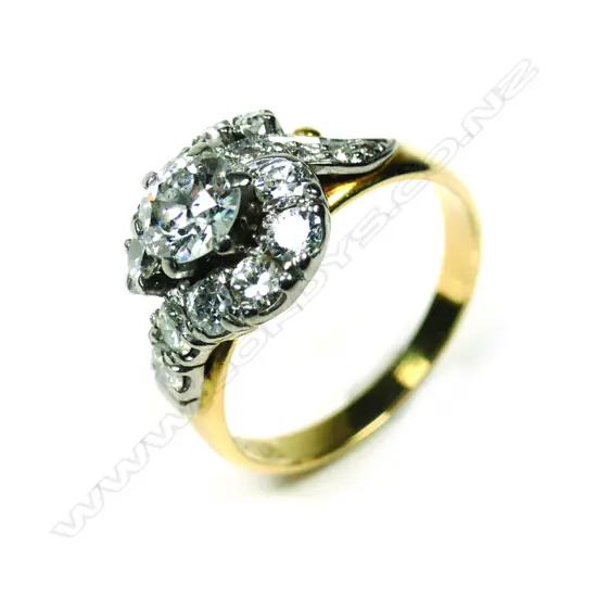 An 18ct gold, diamond solitaire cross-over ring, the central 0.82ct early round brilliant cut graded I-J and I1, framed by 17 further diamonds. TDW 1.93ct. Valuation available.