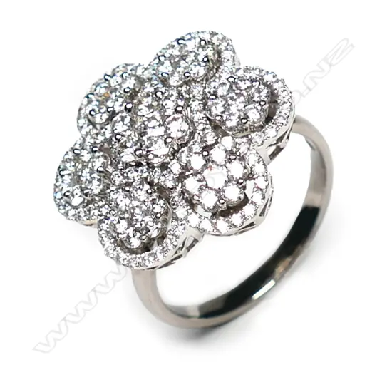 An 18ct white gold and diamond cluster ring, a central cluster of modern round brilliant cut diamonds surrounded by six small clusters of modern round brilliant cut diamonds, set in a decoratively pierced mount, TDW 1.80ct.  Valuation available.