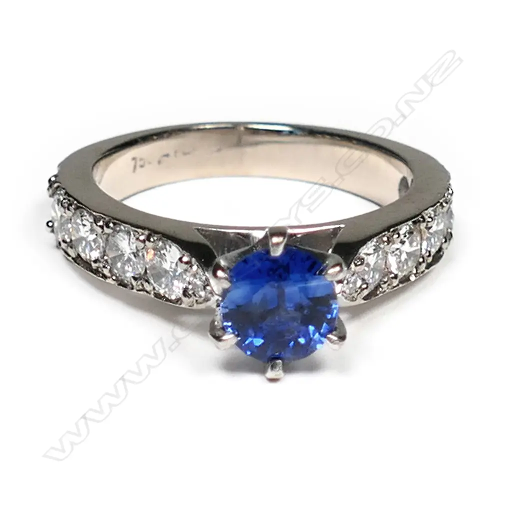 An 18ct white gold sapphire and diamond ring, the 1.17ct oval mixed cut violet blue sapphire claw set with six round modern brilliant diamonds set to each upswept shoulder, TDW 1.22ct.  Valuation available. Image 1++