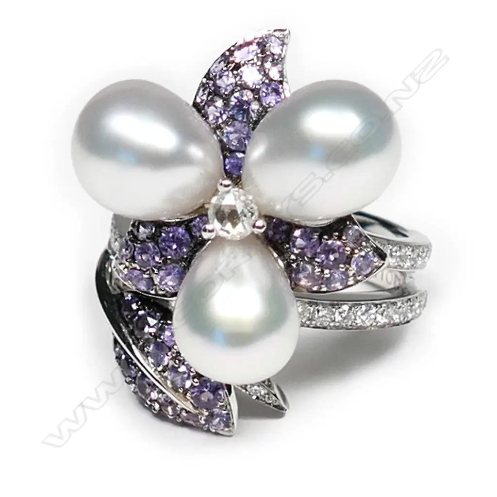 A 18ct white gold Autore purple sapphire pearl and diamond ring, three Autore pearls set to the centre of a diamond and sapphire set floral mount, with further diamonds set to the split shoulders, TDW 0.55ct, TSW 1.40ct.  Valuation available. Image 1++