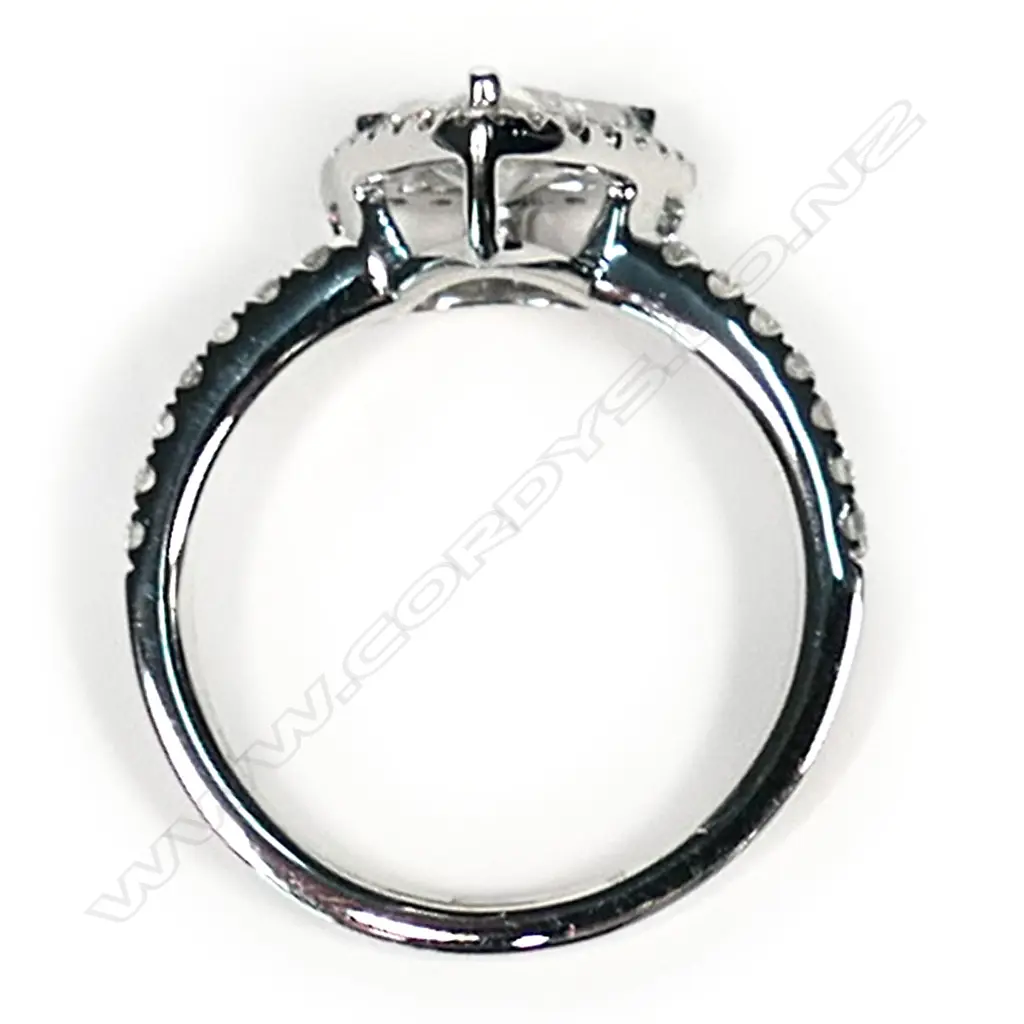A platinum and diamond vintage style halo ring, a 0.92ct trillion cut diamond (J-K colour, I1-I2 clarity), claw set and surrounded by a halo of twenty-one round brilliant cut diamonds (I-K colour, SI1-I2 clarity), with another fourteen round brilliant cut diamonds set to the band (I-K colour, SI1-I2 clarity), TDW 0.33ct ring size M. Image 1++