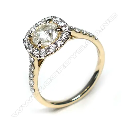 A 14ct gold diamond vintage style halo ring. a 0.73ct round brilliant cut diamond (M-N colour, I1-I2 clarity), claw set and surrounded by a halo of fourteen round brilliant cut diamonds (, I-K colour, SI1-I2 clarity), with a further five diamonds to each shoulder, (I-K colour, SI1-I2 clarity), TDW 1.23ct, ring size I 1/2.