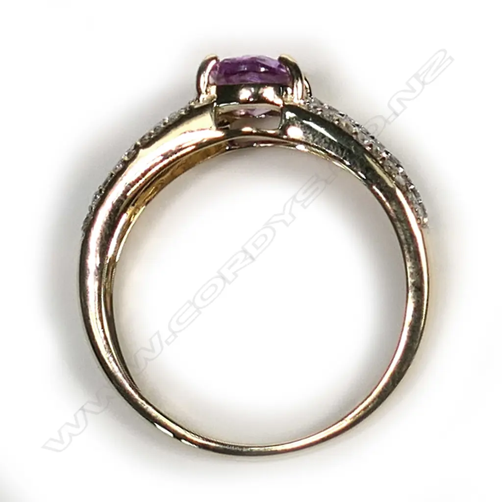 A 14ct gold pink sapphire and diamond ring, a 1.00ct oval cut, deep pink sapphire (slightly included) claw set with twenty-seven round brilliant cut diamonds to each triple band shoulder, (H-L colour, SI1-P2 clarity) TDW 0.24ct, ring size M½. Image 1++