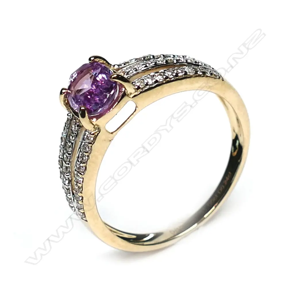 A 14ct gold pink sapphire and diamond ring, a 1.00ct oval cut, deep pink sapphire (slightly included) claw set with twenty-seven round brilliant cut diamonds to each triple band shoulder, (H-L colour, SI1-P2 clarity) TDW 0.24ct, ring size M½. Image 1++