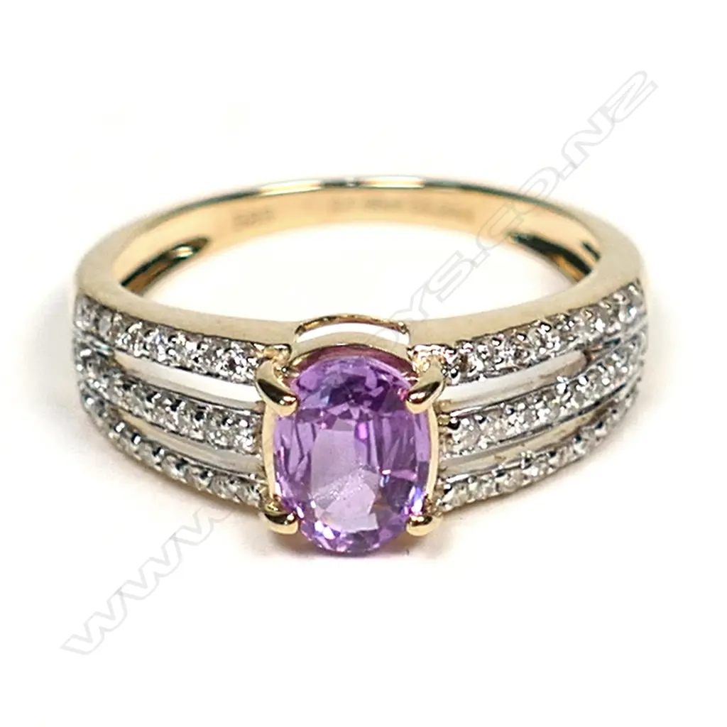 A 14ct gold pink sapphire and diamond ring, a 1.00ct oval cut, deep pink sapphire (slightly included) claw set with twenty-seven round brilliant cut diamonds to each triple band shoulder, (H-L colour, SI1-P2 clarity) TDW 0.24ct, ring size M½. Image 1++