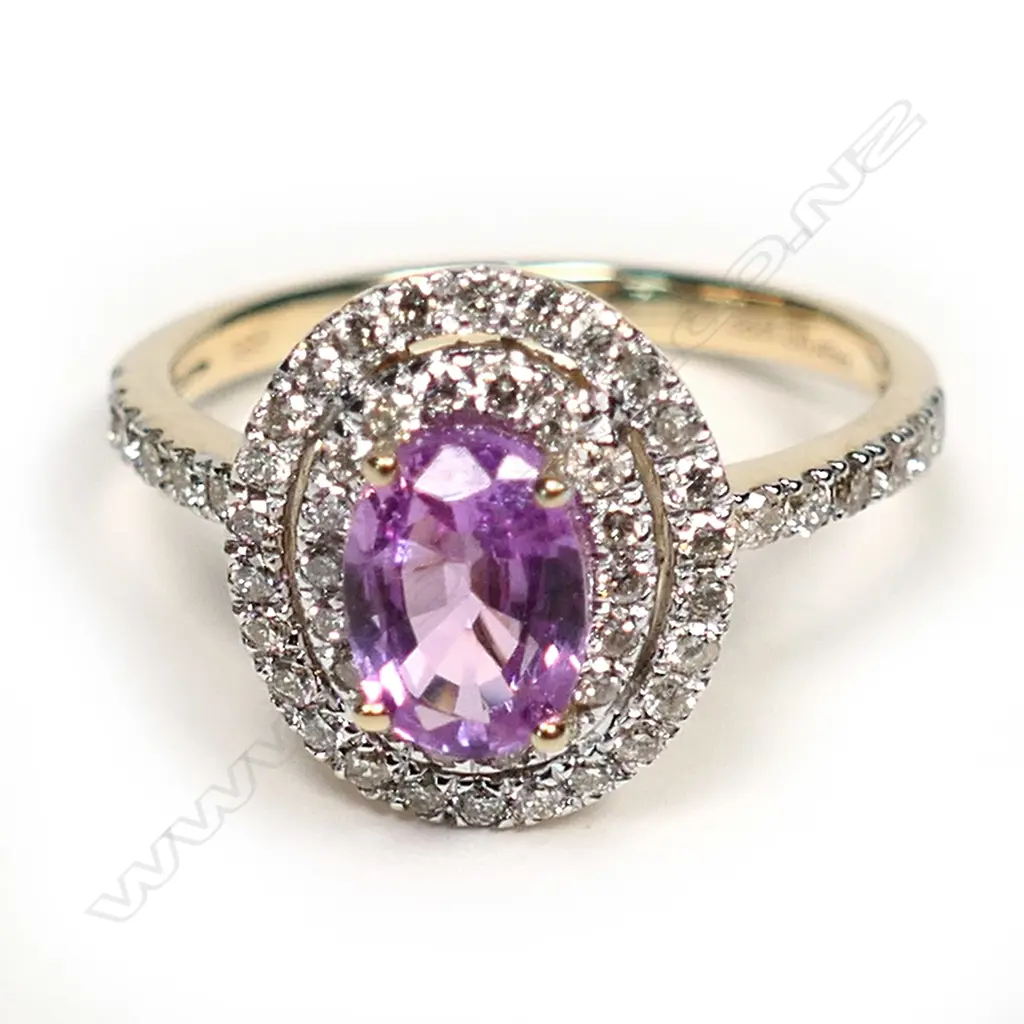 A 14ct gold pink sapphire and diamond double halo ring, a 1.38ct oval cut deep pink sapphire (slightly included), claw set and surrounded by a double halo of round brilliant cut champagne Diamonds (SI1-P2 clarity), with a further six round brilliant cut champagne diamonds to each shoulder, (SI1-P2 clarity), TDW 0.43ct ring size L½. Image 1++