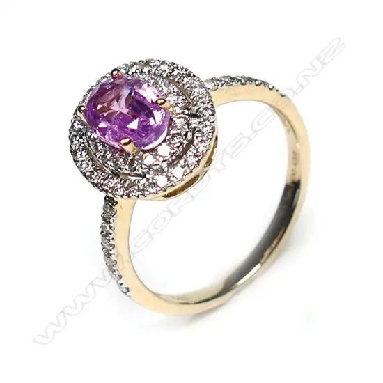 A 14ct gold pink sapphire and diamond double halo ring, a 1.38ct oval cut deep pink sapphire (slightly included), claw set and surrounded by a double halo of round brilliant cut champagne Diamonds (SI1-P2 clarity), with a further six round brilliant cut champagne diamonds to each shoulder, (SI1-P2 clarity), TDW 0.43ct ring size L½.