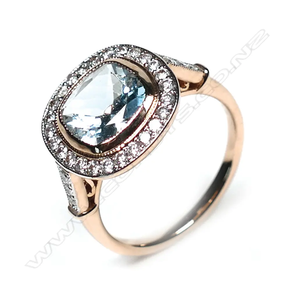 A 14ct rose gold aquamarine and diamond ring, a 1.75ct square cushion cut greyish-blue aquamarine (eye clean clarity), bezel set and surrounded by a halo of twenty-six round brilliant cut diamonds with a further three diamonds to each shoulder, (H-J colour, SI2-I2 clarity), TDW 0.43ct ring size N. Image 1++