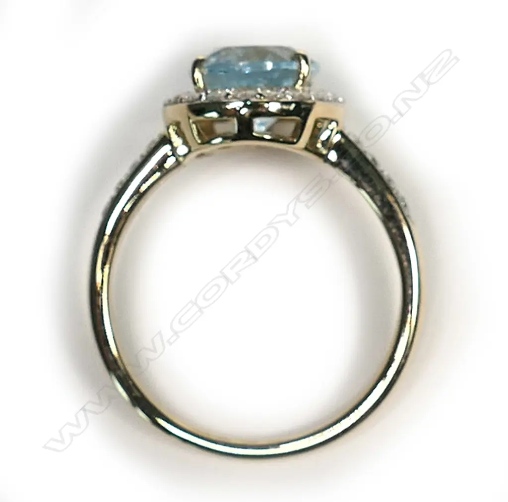 A 14ct gold, aquamarine and diamond halo ring, a 2.54ct oval cut greyish-blue aquamarine (eye visible inclusions), claw set and surrounded by a halo of round brilliant cut diamonds with a further four diamonds set to each shoulder, (H-J colour, SI1-I2 clarity), TDW 0.41ct, ring size P. Image 1++