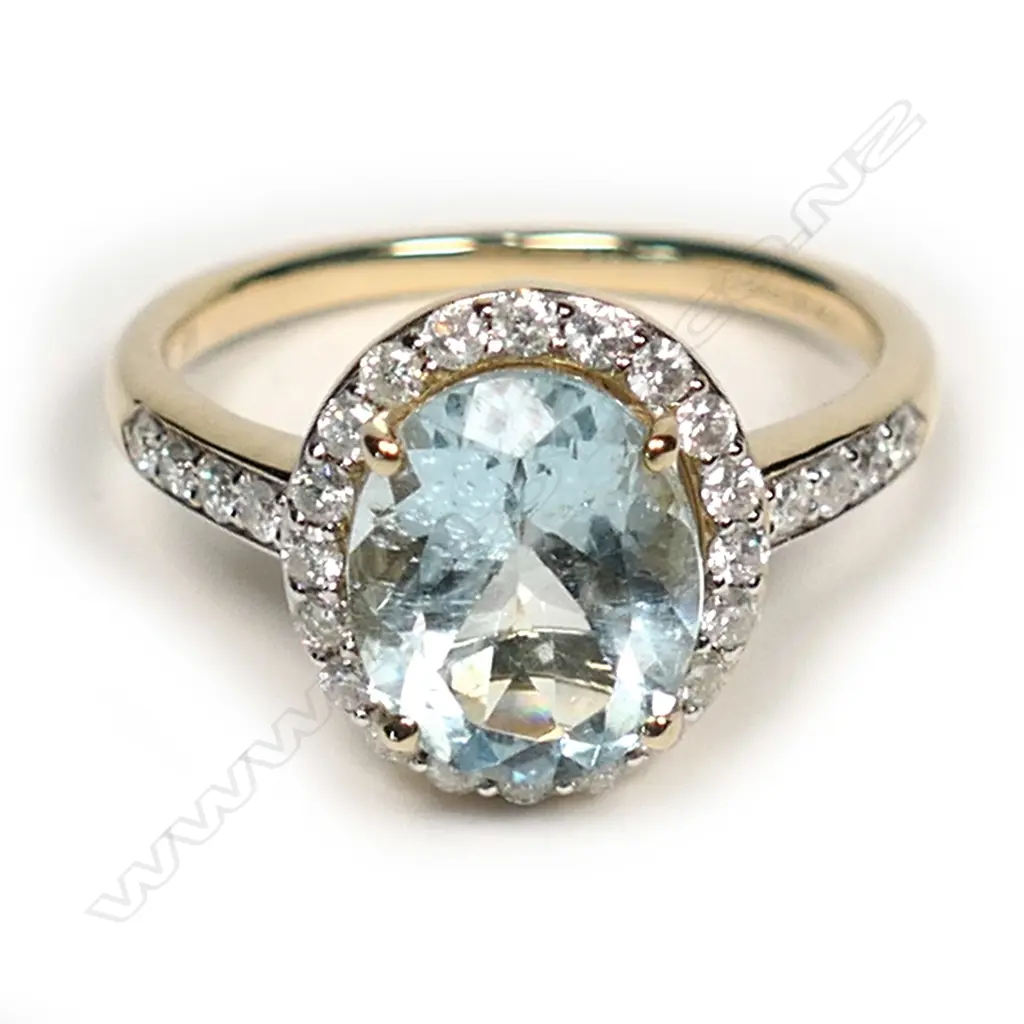 A 14ct gold, aquamarine and diamond halo ring, a 2.54ct oval cut greyish-blue aquamarine (eye visible inclusions), claw set and surrounded by a halo of round brilliant cut diamonds with a further four diamonds set to each shoulder, (H-J colour, SI1-I2 clarity), TDW 0.41ct, ring size P. Image 1++